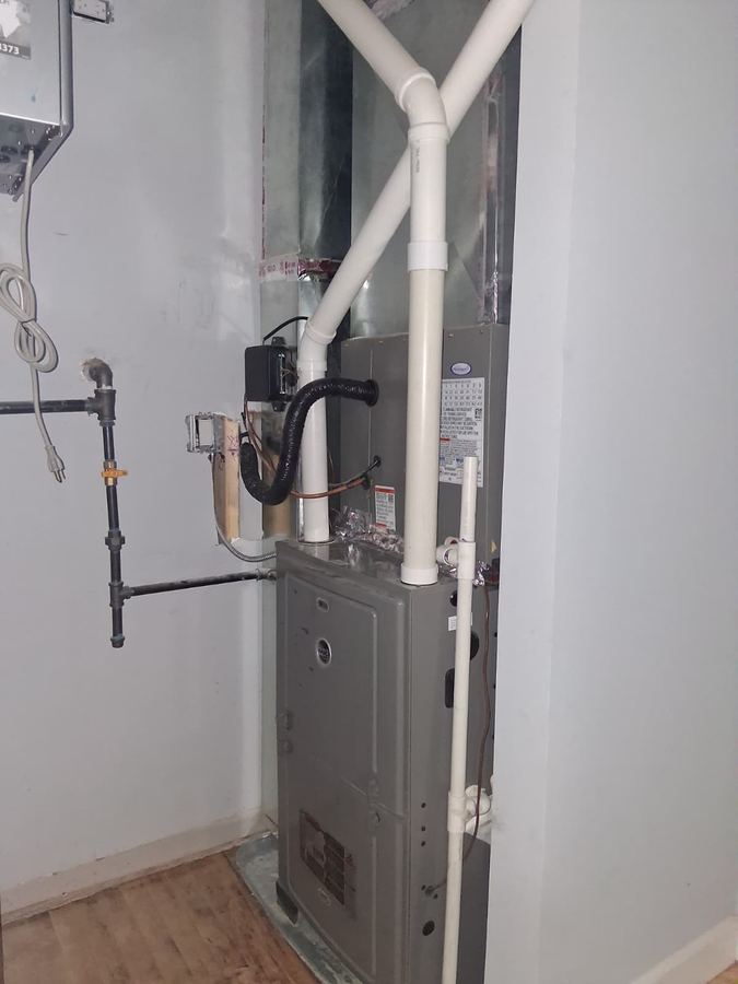 High-efficiency gas furnace with PVC intake and exhaust in a residential closet