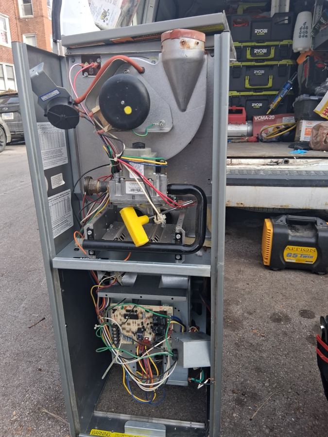 Furnace opened for service showing blower, gas valve and control board